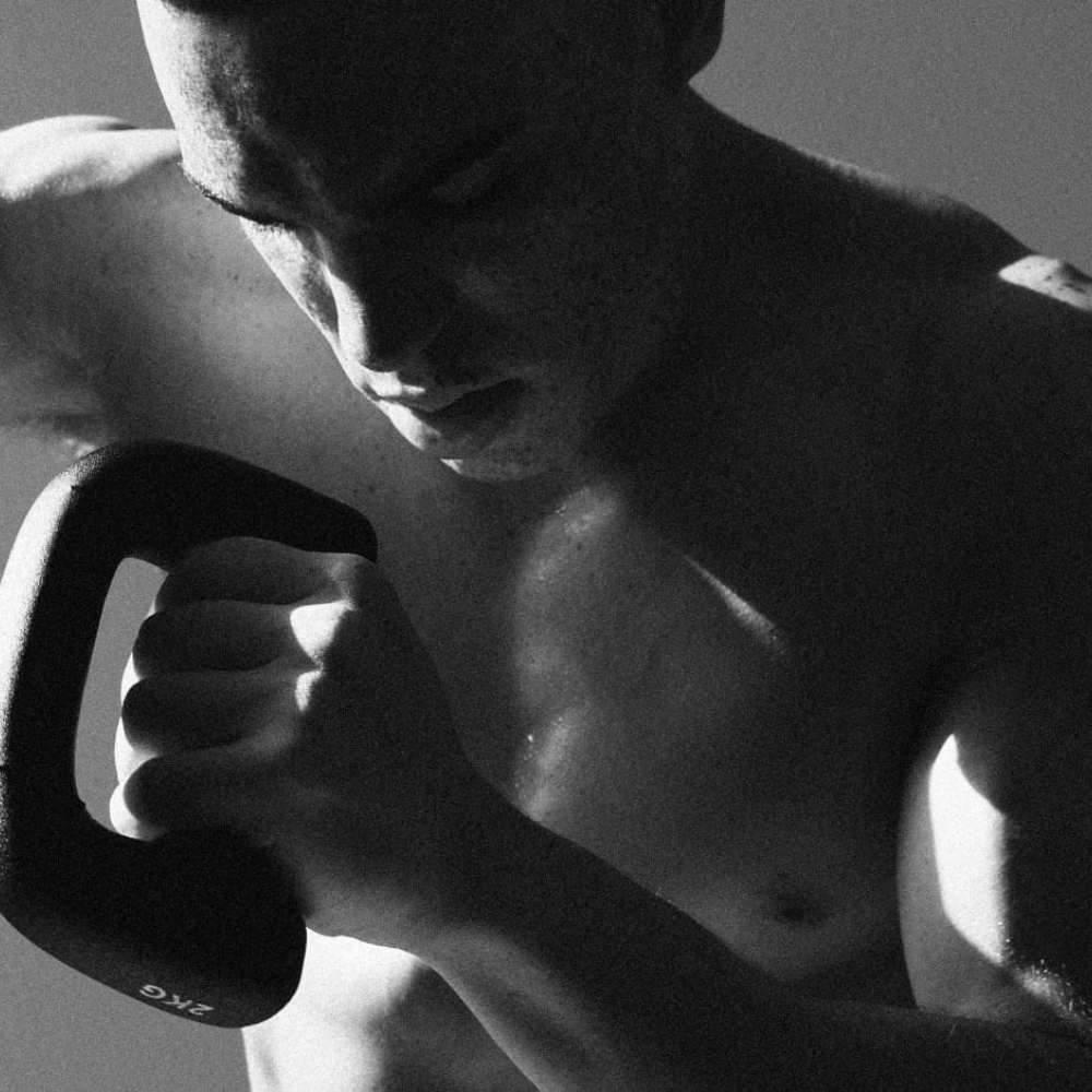 Athlete Working Out Using D-shaped Dumbbells

