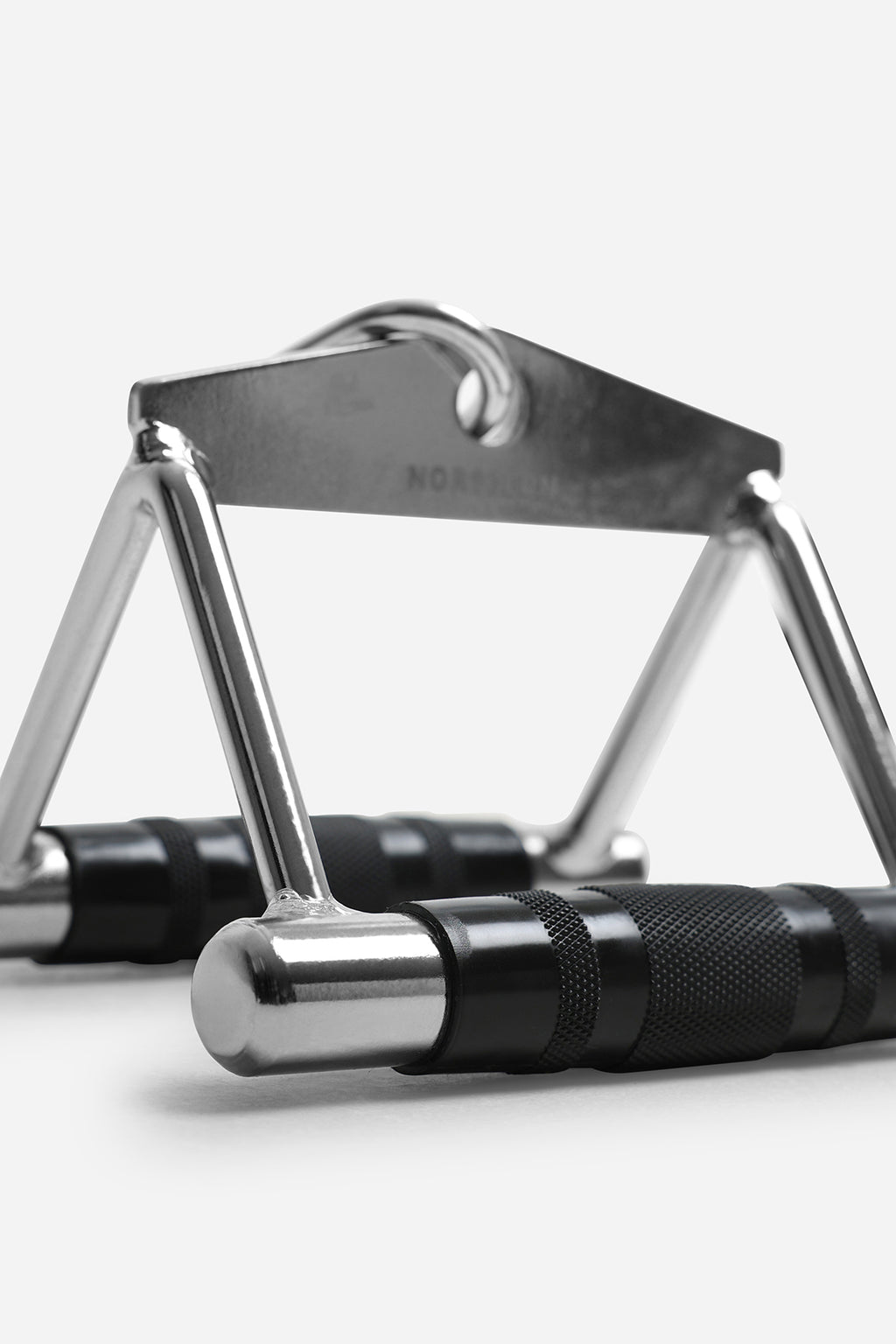 Close-up of cable row handle featuring textured knurled grips and heavy-duty steel frame