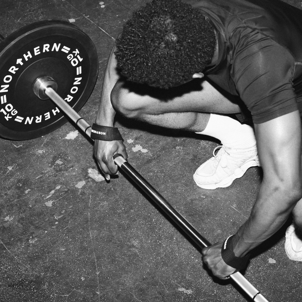 Starting deadlift workout and using barbell with Olympic bumper plates  